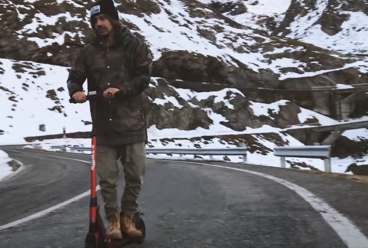 Video thumbnail showing black E-TWOW S2 ECO electric scooter with play button overlay.