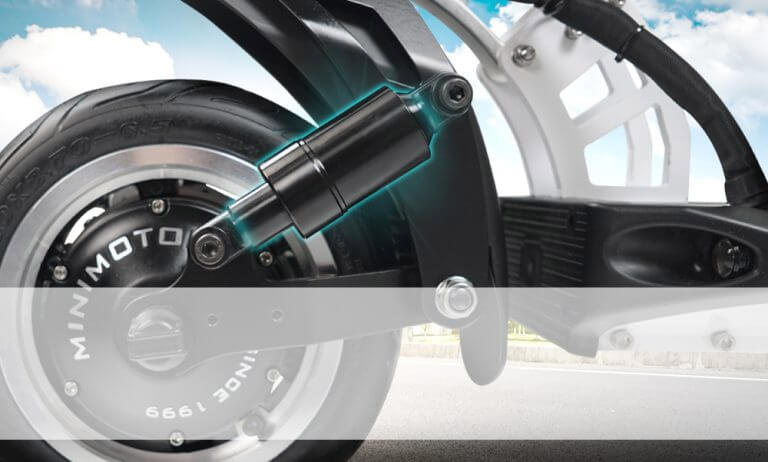 Close-up of Speedway 5 rear dual suspension system with visible shock absorber and motor hub