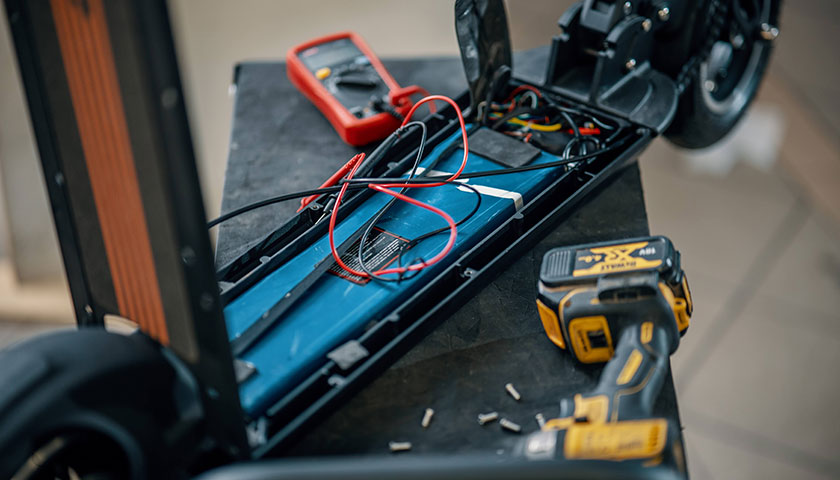 An image showing dissasembled electric scooter, where you can see the battery in it.