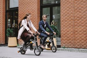 Man and woman riding the Stigo electric bikes on the street.