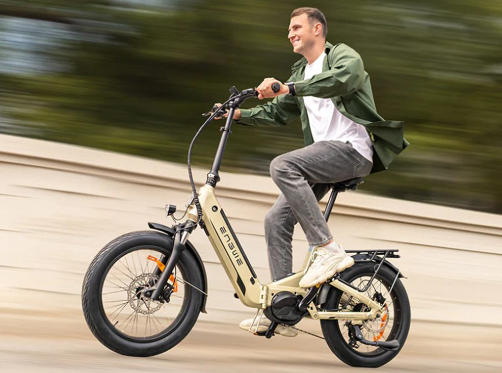 A man riding on the champagne Engwe L20 3.0 Pro electric bicycle demonstrating the 100Nm mid-drive motor.