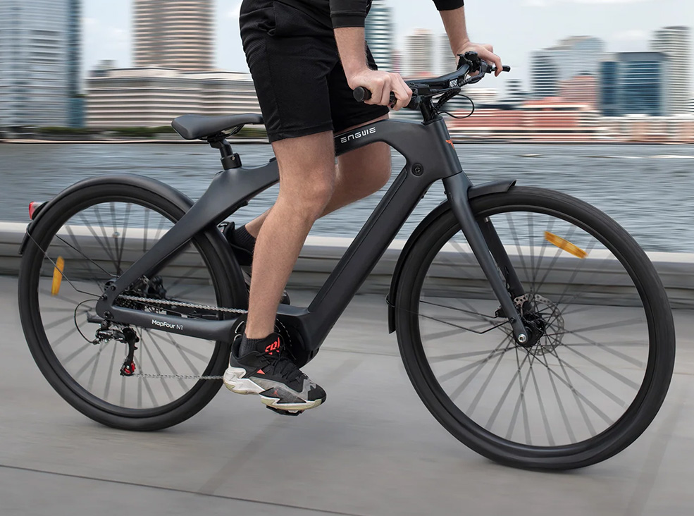 Man riding the Engwe Mapfour N1 Pro Electric Bicycle by the seashore in the city.