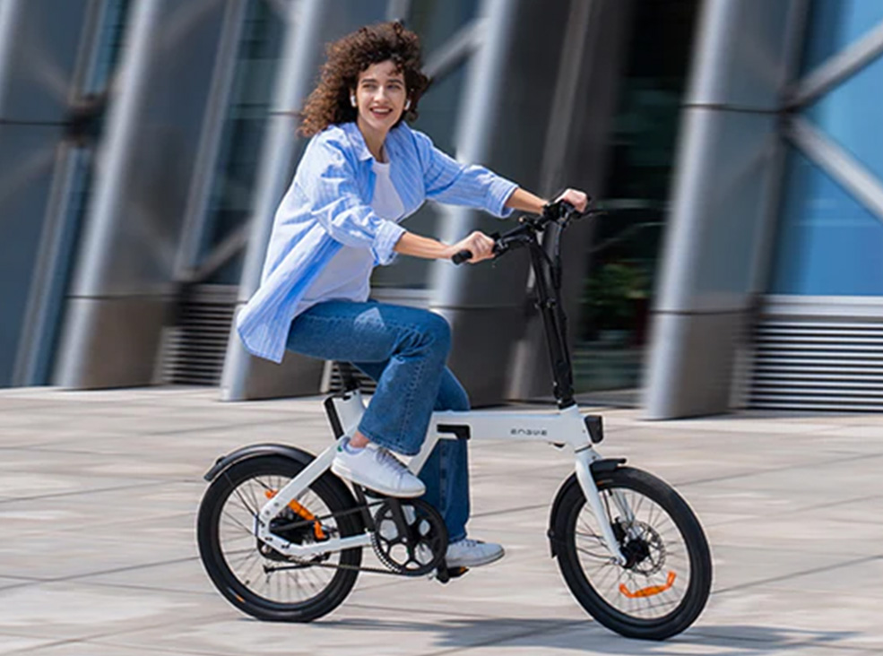 Woman riding the white Engwe P20 electric bike outdoors