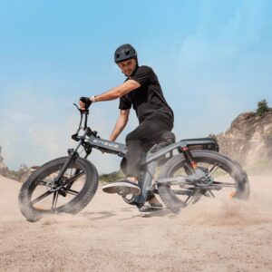 Man making an offroad turn on sand or dirt with the Engwe X26 electric bicycle wearing a helmet.