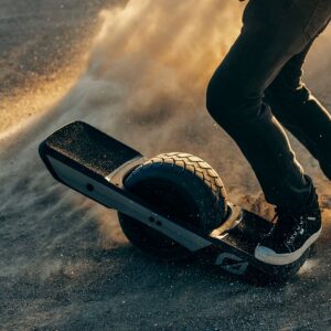 Man riding the Onewheel GT Treaded on offroad.