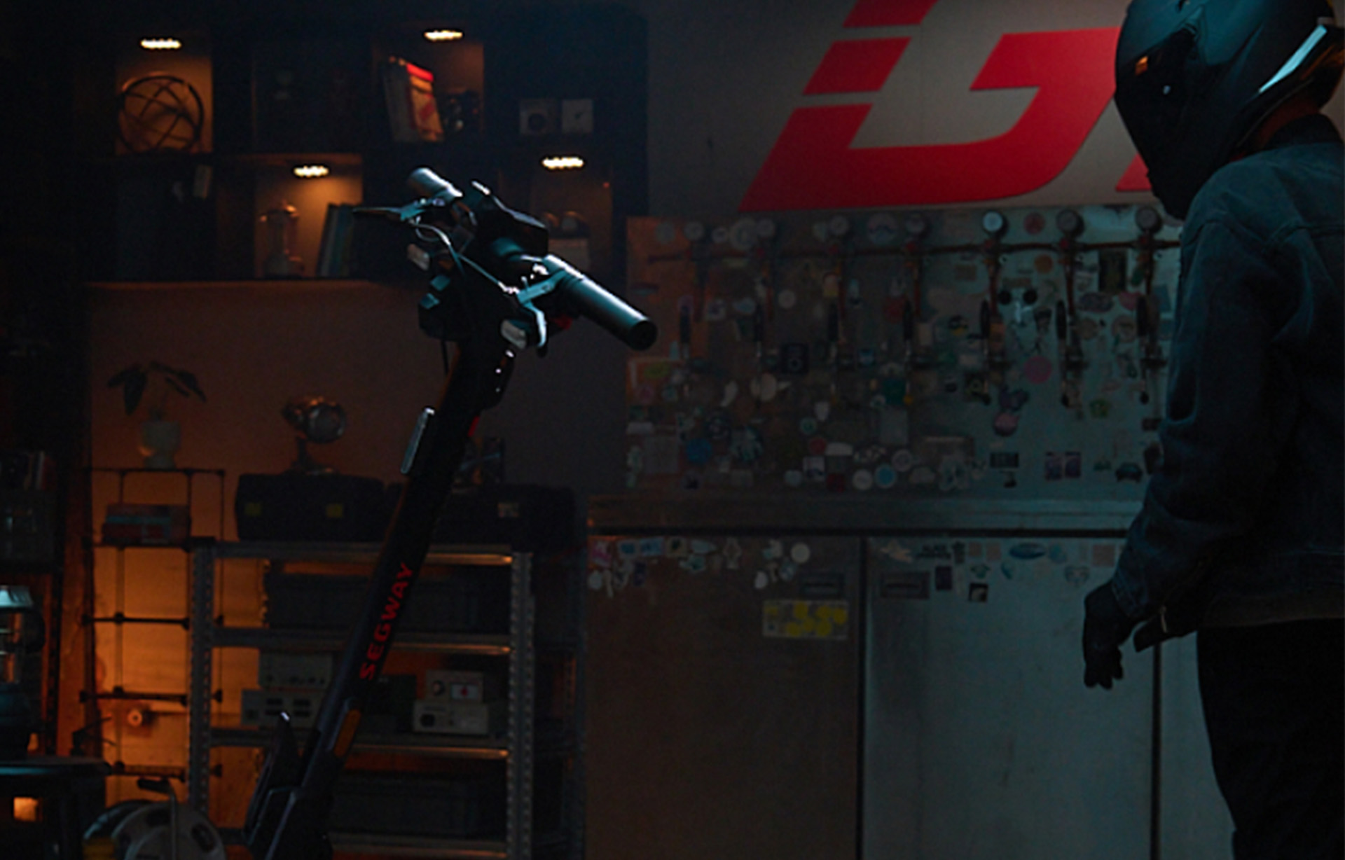 Segway-Ninebot GT3 Pro electric scooter in a dimly lit garage automatically activates its AirLock feature as the rider wearing a helmet approaches, demonstrating proximity-based unlocking technology.