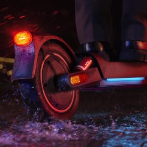 Rear view image of the Xiaomi Electric Scooter 5 Max in the rain during the night.