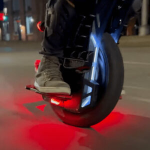 Close-up view of a man riding the Begode ET MAX electric unicycle on the city street.