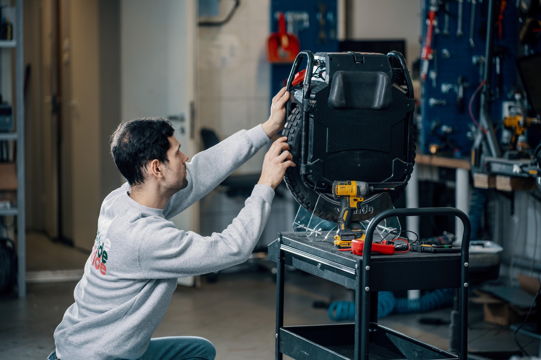 Technician repairing an electric unicycle in a workshop